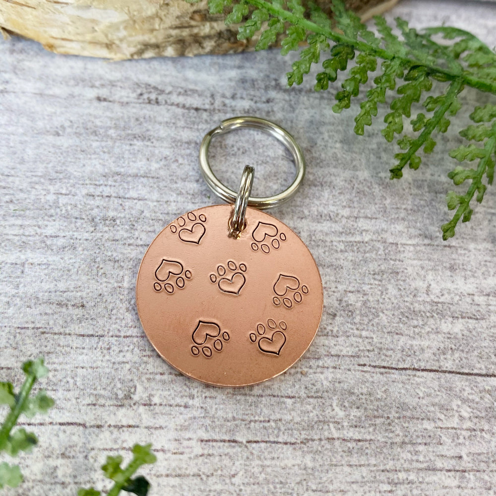 
            
                Load image into Gallery viewer, baby paw prints dog tag
            
        