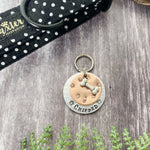 mucky paw prints dog tag
