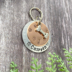 mucky paw print dog tag